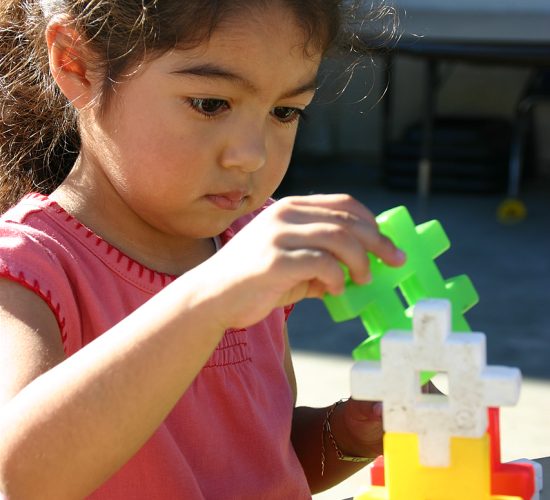 Image of a small child using building blocks